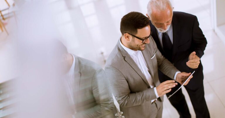 2 businessmen using Lane faxing services through mobile app discussing how important faxing is in the digital age