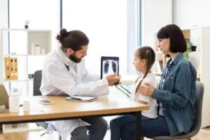 pediatric office staff processing a school sports physical form sent by fax