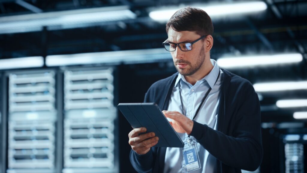 IT manager reviewing a fax cost analysis comparing legacy servers and cloud fax