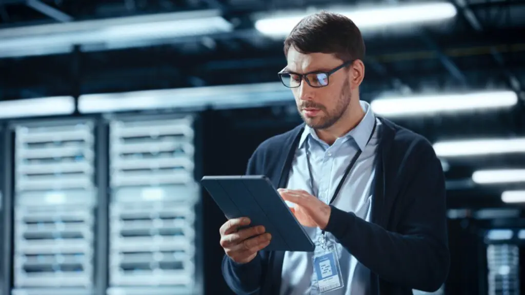 IT manager reviewing a fax cost analysis comparing legacy servers and cloud fax