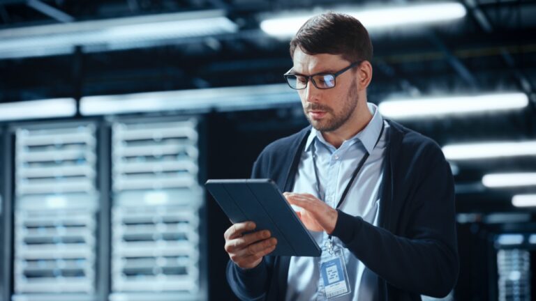 IT manager reviewing a fax cost analysis comparing legacy servers and cloud fax