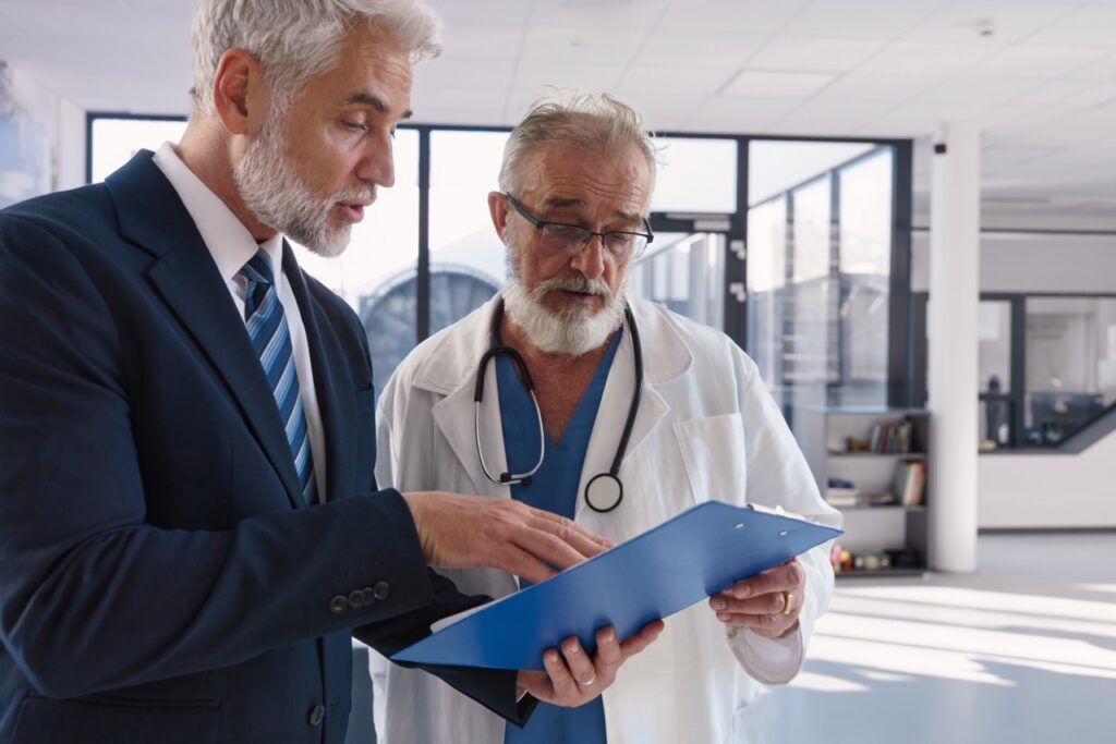 Hospital manager and physician reviewing vendor documents as part of fax vendor communication