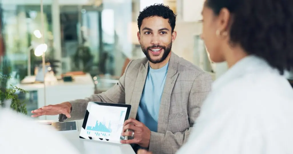 Administrator reviewing inbound fax queue management metrics on a tablet with a colleague