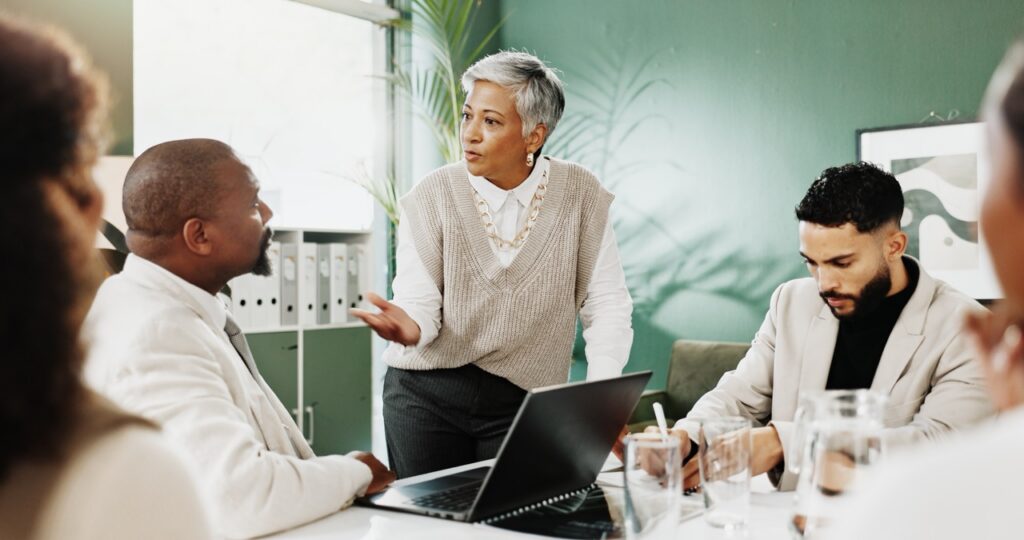 Executive leading a team discussion that challenges common fax myths about cost and compliance